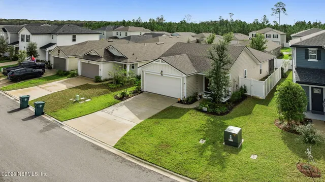 an aerial view of a house with yard
