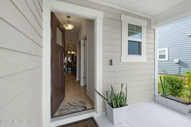a view of a hallway with closet and a potted plant