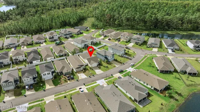 an aerial view of a house with a lake view