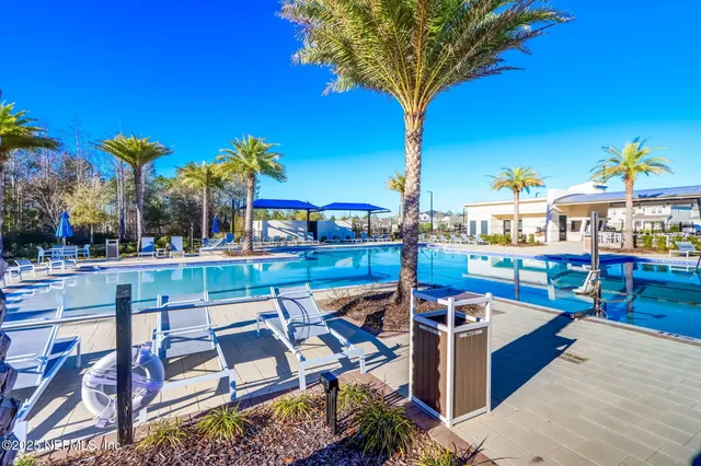 a view of a swimming pool with chairs