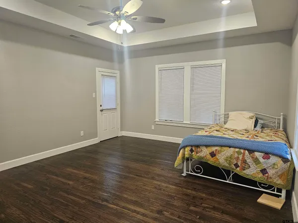 a bedroom with a bed and a chandelier