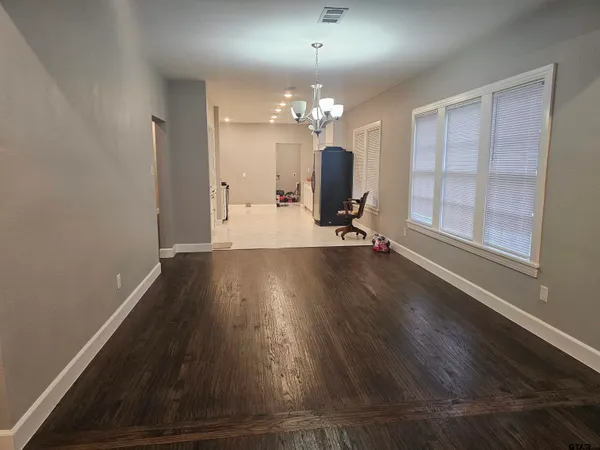 a view of a room with wooden floor and a large window