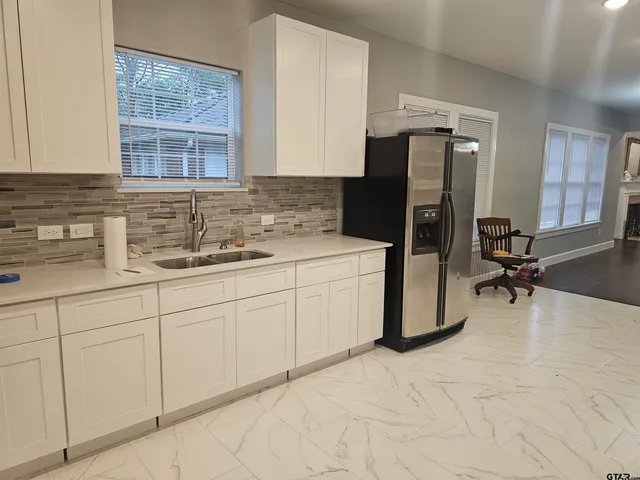 a kitchen with a sink cabinets and appliances
