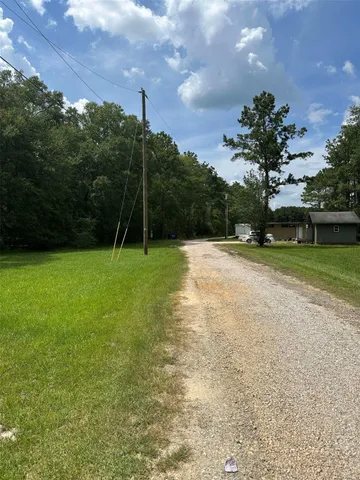a backyard of a house with lots of green space and plants