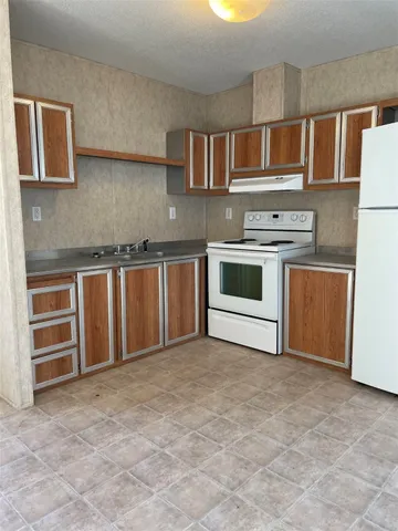a kitchen with stainless steel appliances granite countertop a stove and cabinets