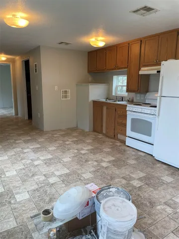 a kitchen with a sink cabinets and appliances