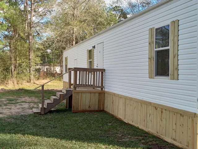 a view of a backyard with wooden fence