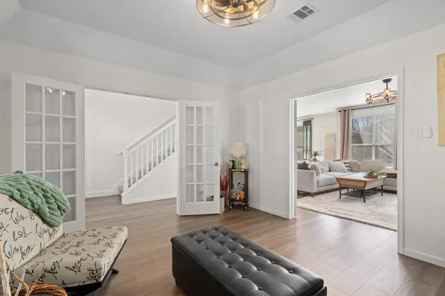 a living room with furniture and wooden floor