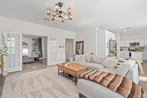 a living room with furniture and a chandelier