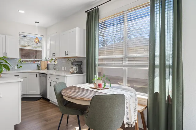 a kitchen with kitchen island granite countertop a sink cabinets and wooden floor