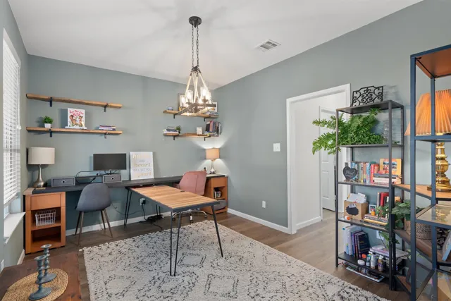 a view of a room with workspace and lots of stuff