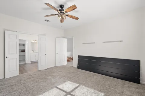 a bathroom with double vanity sinks a vanity a lamp and a mirror