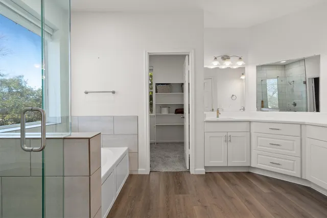 a bathroom with a shower sink and mirror