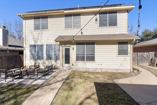 a view of a backyard with wooden fence