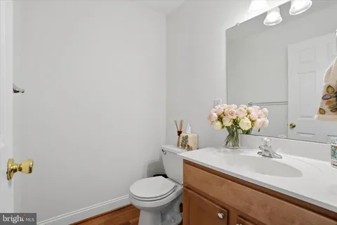 a bathroom with a sink toilet and mirror