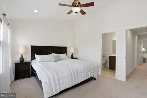a bedroom with a bed and a ceiling fan