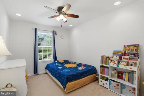 a bedroom with a bed and a book shelf