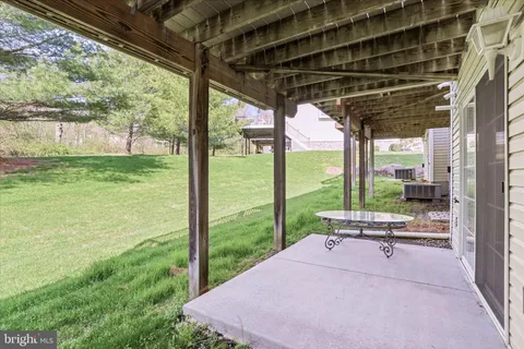 a view of a porch with furniture and garden