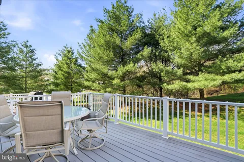 a view of a chair and table on the wooden deck