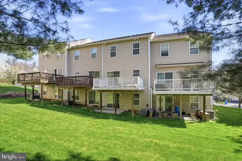 a view of a house with a yard and sitting area