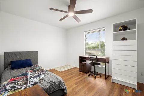 a bedroom that has a bed and a desk in it