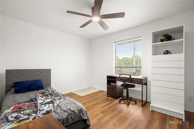 a bedroom that has a bed and a desk in it