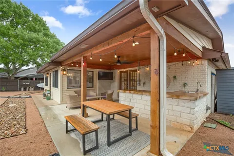 a view of a patio with a table and chairs