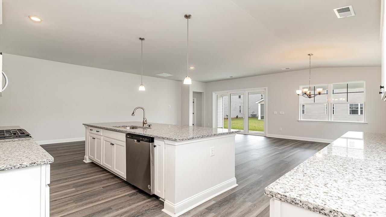 108 Fair Meadow Loris, SC 29569 - Photo 14 of 24 Kitchen featuring stainless steel dishwasher, sink, dark wood-type flooring, and an island with sink