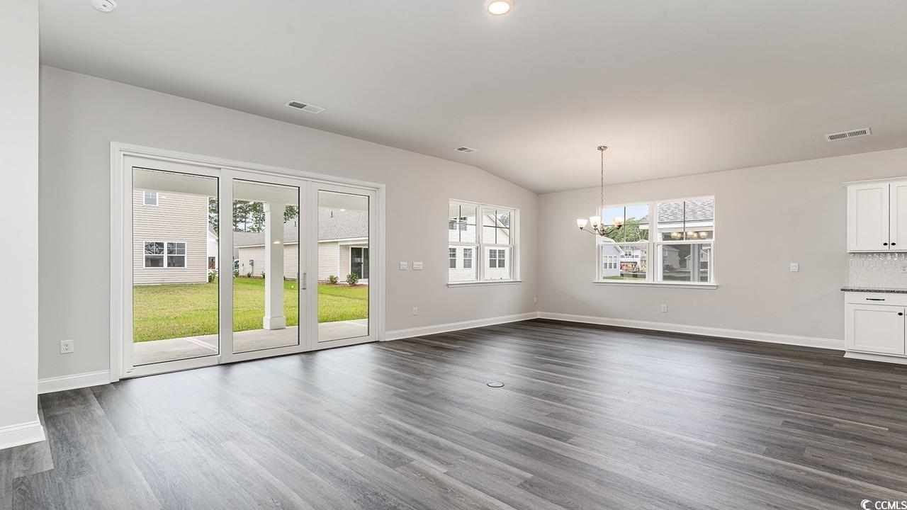 108 Fair Meadow Loris, SC 29569 - Photo 20 of 24 Unfurnished living room featuring lofted ceiling, a notable chandelier, and dark hardwood / wood-style flooring
