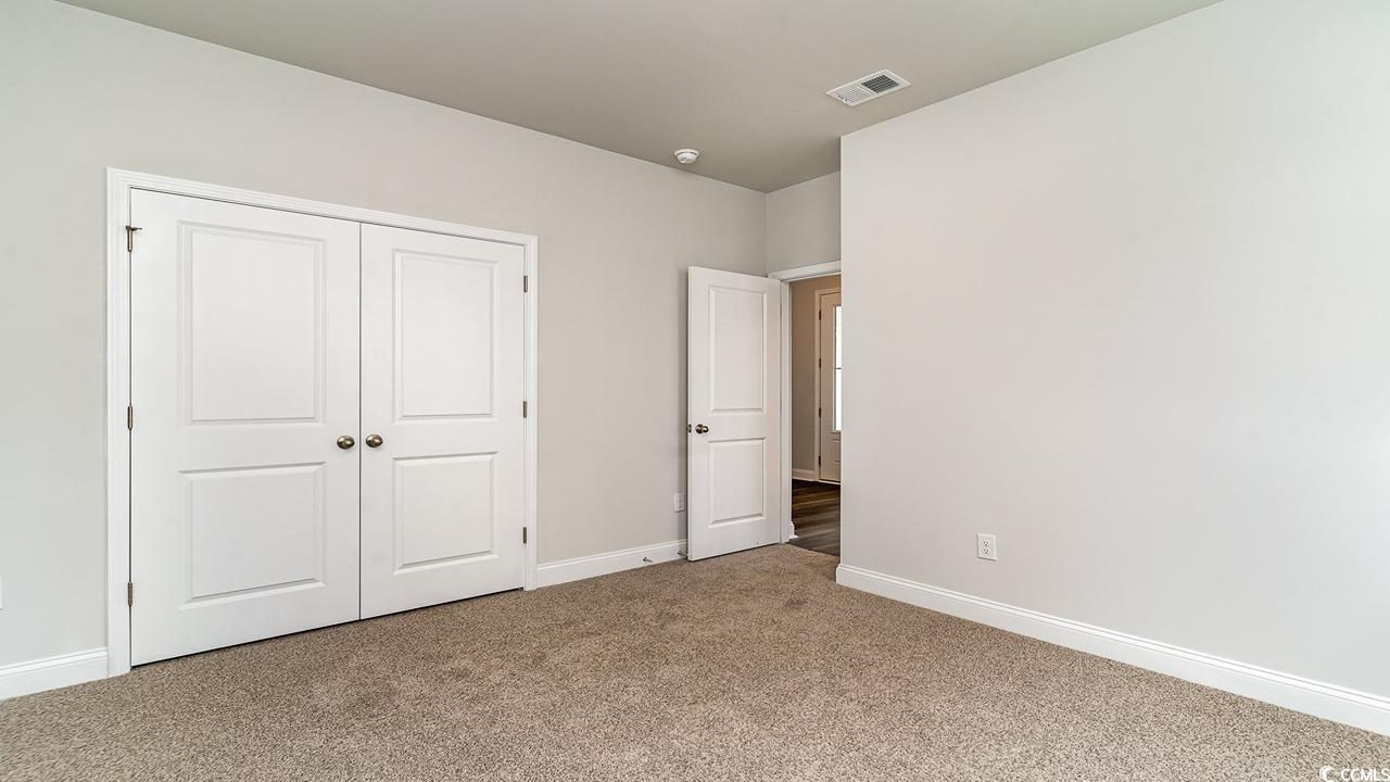 108 Fair Meadow Loris, SC 29569 - Photo 8 of 24 Unfurnished bedroom featuring a closet and carpet floors
