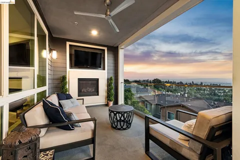 a view of a balcony with a table and chairs