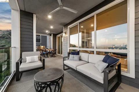a view of a balcony with a table and chairs