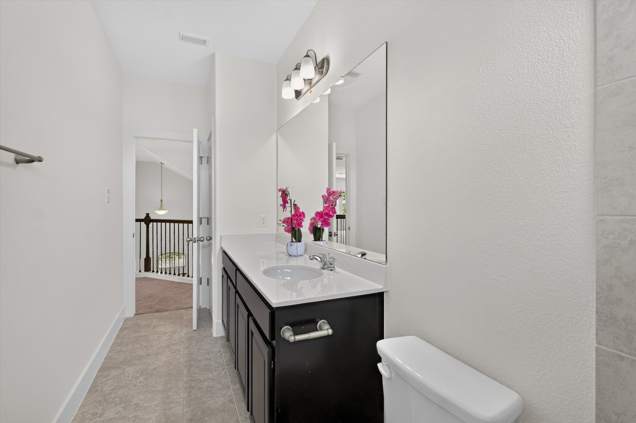 2004 Garretts Way Manchaca, TX 78652 - Photo 28 of 35 A spacious vanity with dual sinks anchors this modern washroom featuring large format tile floors.