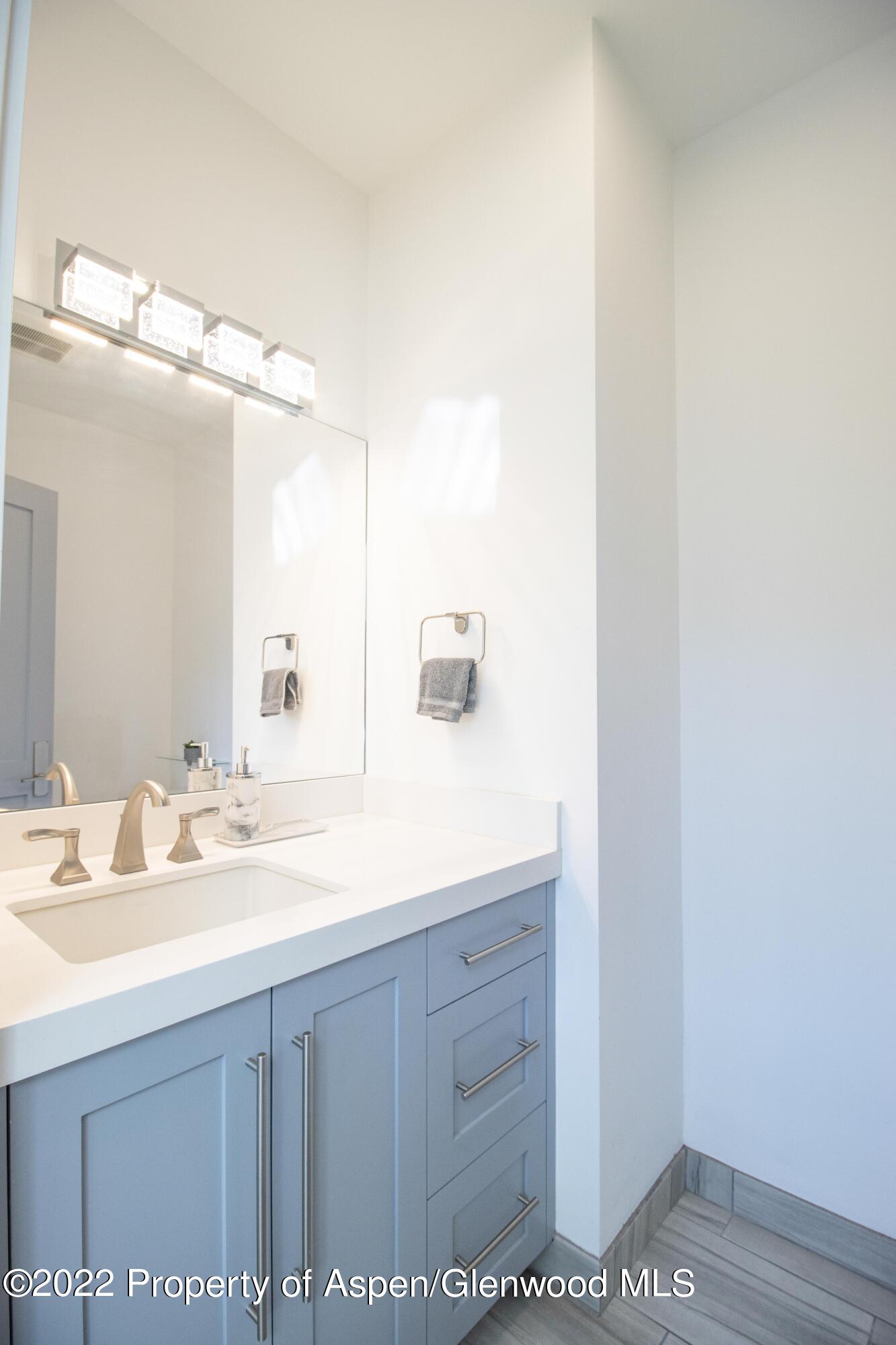 715 Eagles Nest Drive Silt, CO 81652 - Photo 13 of 19 a bathroom with a sink a vanity and mirror