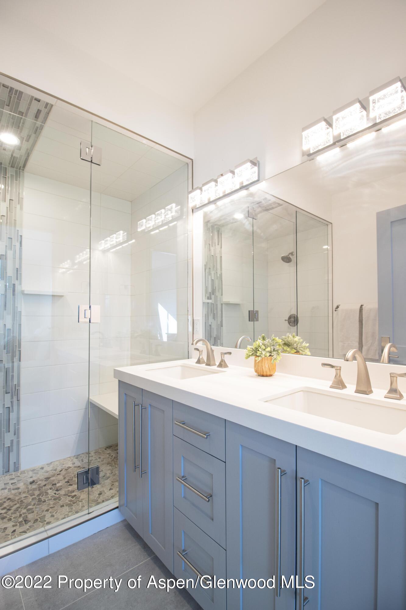 715 Eagles Nest Drive Silt, CO 81652 - Photo 10 of 19 a bathroom with a double vanity sink mirror and shower