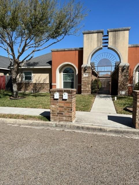 4708 North Cypress Street Pharr, TX 78577 - Photo 2 of 10 View of front facade featuring a gate, stucco siding, and fence