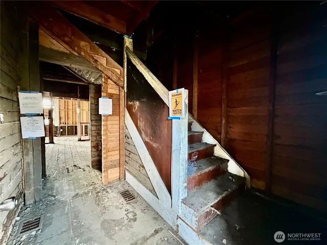 a view of a room with wooden walls and stairs