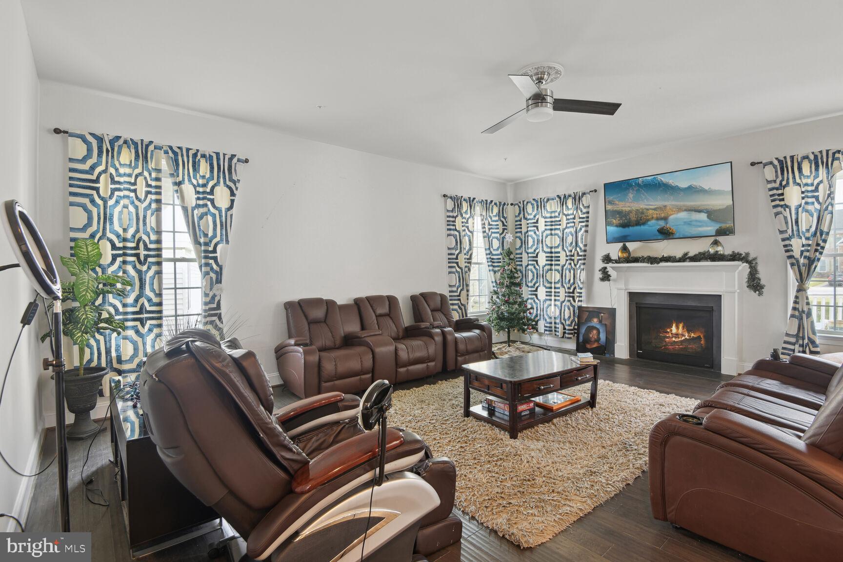 14607 Parkgate Drive Laurel, MD 20707 - Photo 5 of 25 Family room with a fire place and ceiling Fan.
