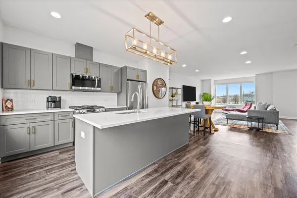 a kitchen with counter top space a sink cabinets and appliances