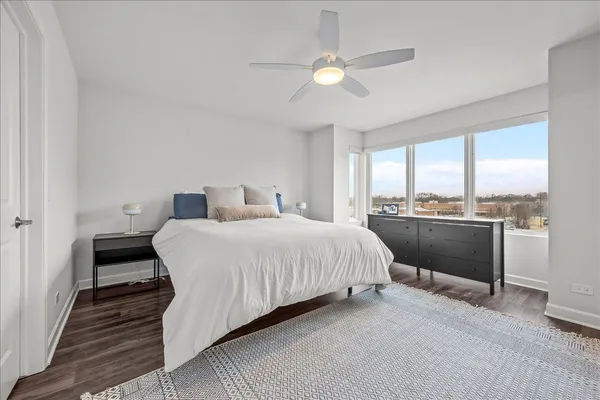 a bedroom with a bed and a large window