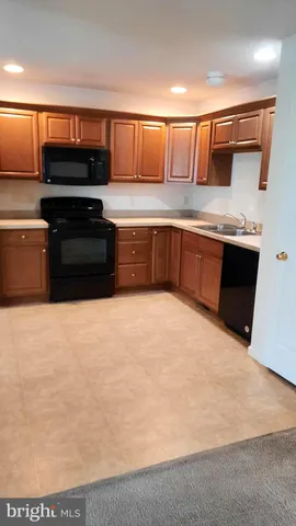 a kitchen with stainless steel appliances a stove a microwave and sink
