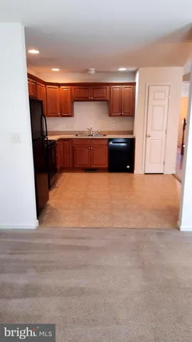 a living room with a furniture and kitchen view