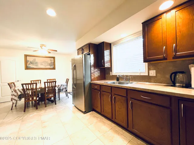 a kitchen with stainless steel appliances granite countertop a stove top oven a sink and dishwasher
