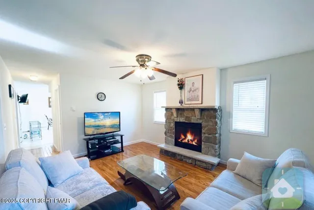 a living room with furniture and a wooden floor