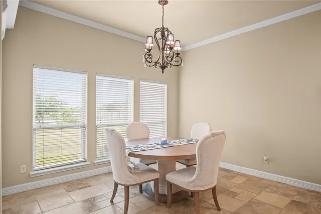 a dining room with furniture window and outside view