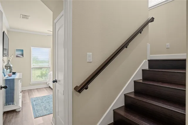 a view of entryway and hall with wooden floor