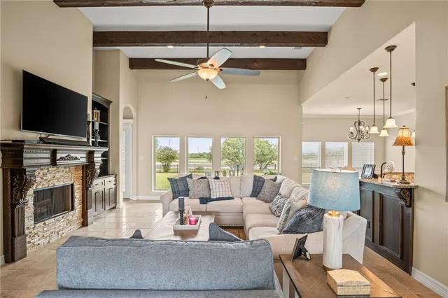 a living room with furniture a flat screen tv and a fireplace