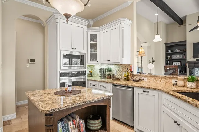 a kitchen with stainless steel appliances granite countertop a sink stove and cabinets