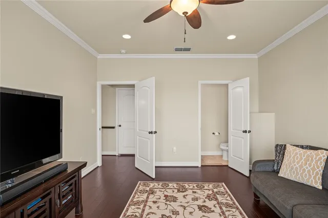 a living room with a flat screen tv and rug