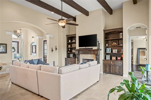 a living room with furniture a flat screen tv and a fireplace